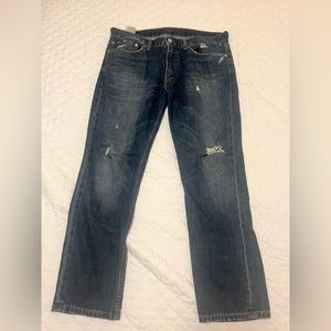 Lightly worn pair of Levi’s 511 Slim Fit jeans blue distressed